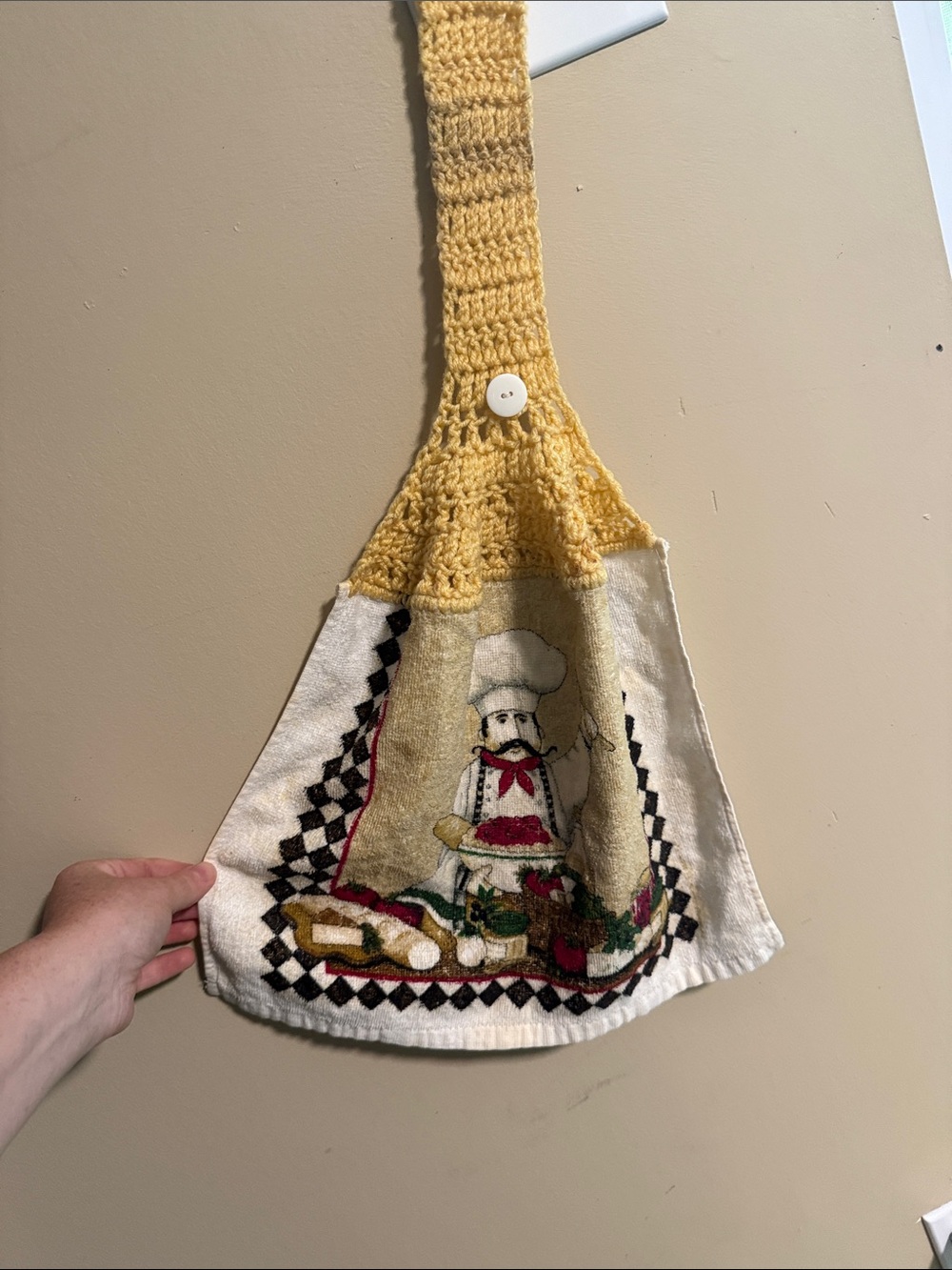 Vintage handmade yellow-topped crochet hanging kitchen towel featuring a chef